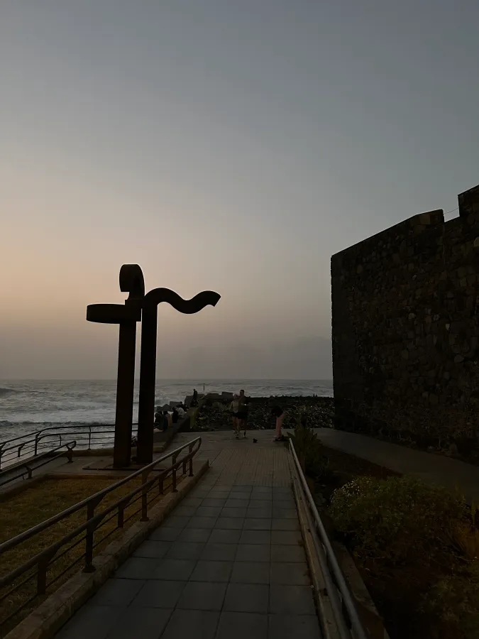 Castillo de San Felipe black sand beach and sculptures at sunset for Tenerife travel review