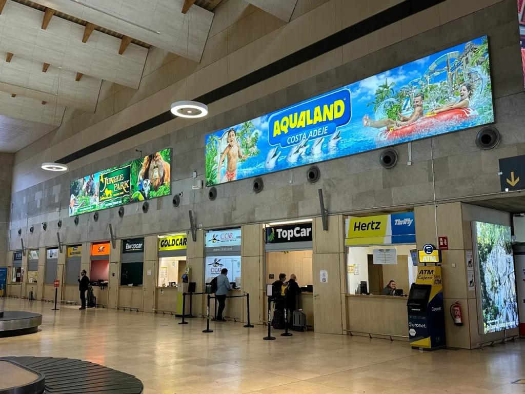 Tenerife travel review, rental car offices lined up inside the Tenerife airport arrival hall.