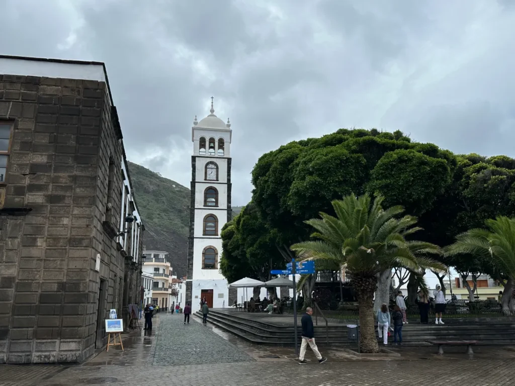 Tenerife travel review, a beautiful town plaza with historic buildings and lush palm trees.